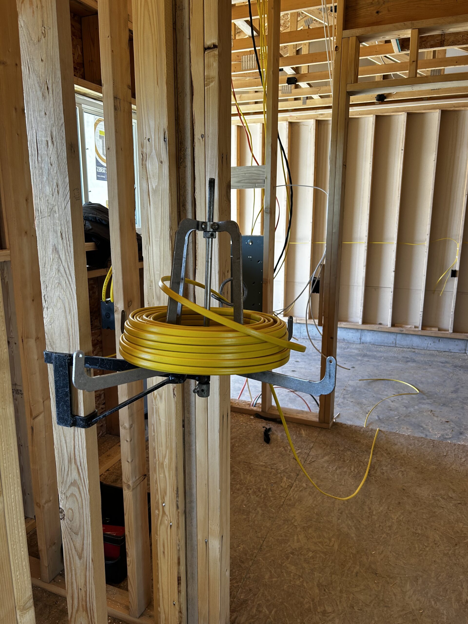 spool of yellow electrical wire in framed building