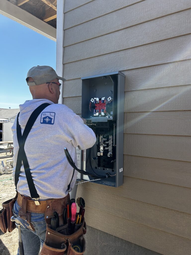 Electrical electrician working on exterior residential electrical panel