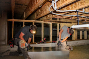 hvac technicians working in residential crawlspace